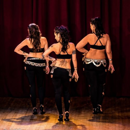 Three dancers with finger cymbals