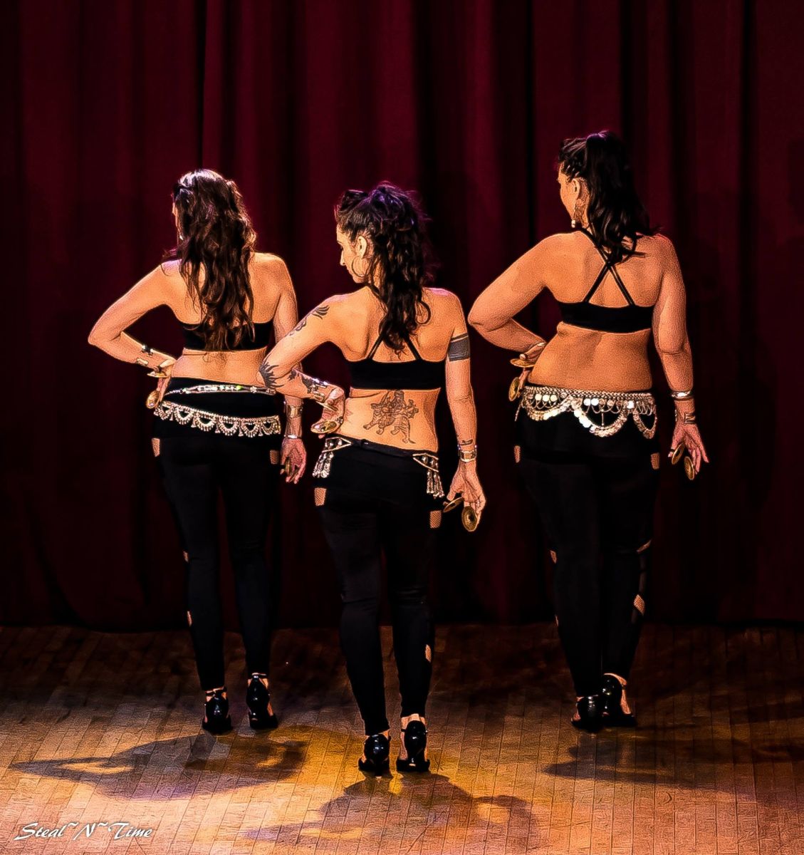 Three dancers with finger cymbals